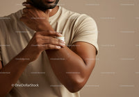 Man Applying Moisturizer to Arm for Skin Hydration and Softness
