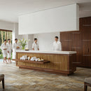 Spa guests in white robes arriving at modern reception desk