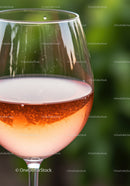 Close up of sparkling rosé wine in glass outdoors