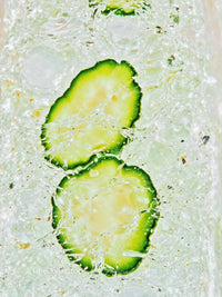 Refreshing cucumber slices in sparkling water close up