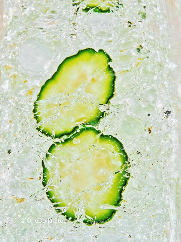 Refreshing cucumber slices in sparkling water close up