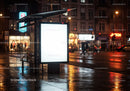 Nighttime Urban Bus Stop Shelter with Bright Advertisement Panel