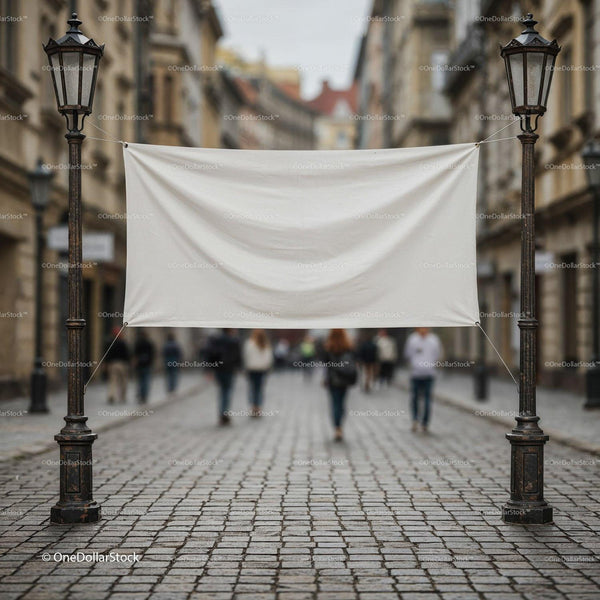 Blank banner hanging between street lamps on cobblestone road JPG Mockup Image