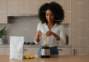 Young Woman Preparing Banana Smoothie in Modern Kitchen