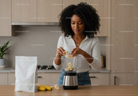 Young Woman Preparing Banana Smoothie in Modern Kitchen