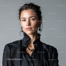 Elegant Woman with Black Dress and Jewelry on Gray Background