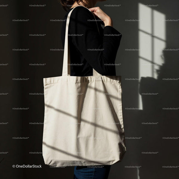 Minimalist canvas tote bag carried by woman in shadow JPG Mockup Image