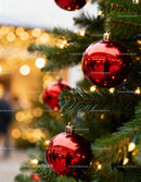 Christmas tree with shiny red baubles and warm lights