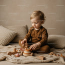 Toddler Playing with Wooden Toys in Cozy Neutral Room