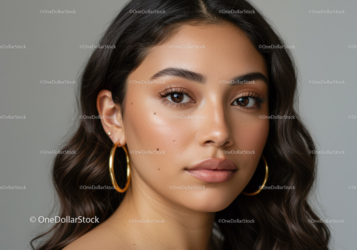 Elegant Woman with Gold Hoop Earrings and Flawless Skin