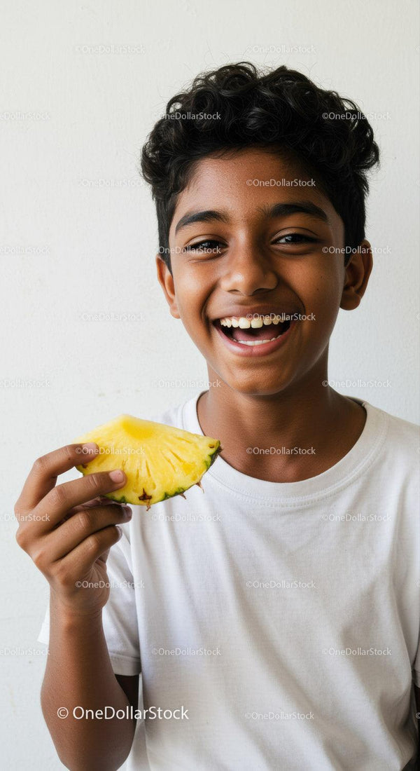 Smiling Boy Enjoying Pineapple Slice in Bright Casual Setting