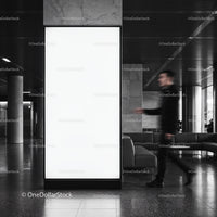 Blurred man walking past large blank indoor billboard