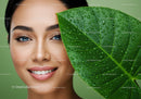 Close-up of a Woman with Blue Eyes and Green Leaf with Water Droplets