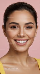 Smiling young woman with radiant skin on pink background