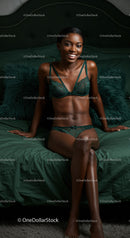 Smiling woman in elegant lingerie sitting on bed