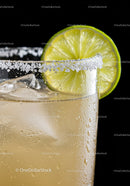 Refreshing cocktail with salted rim and lime wedge