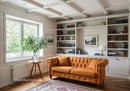 Cozy living room with orange sofa and built-in bookshelves