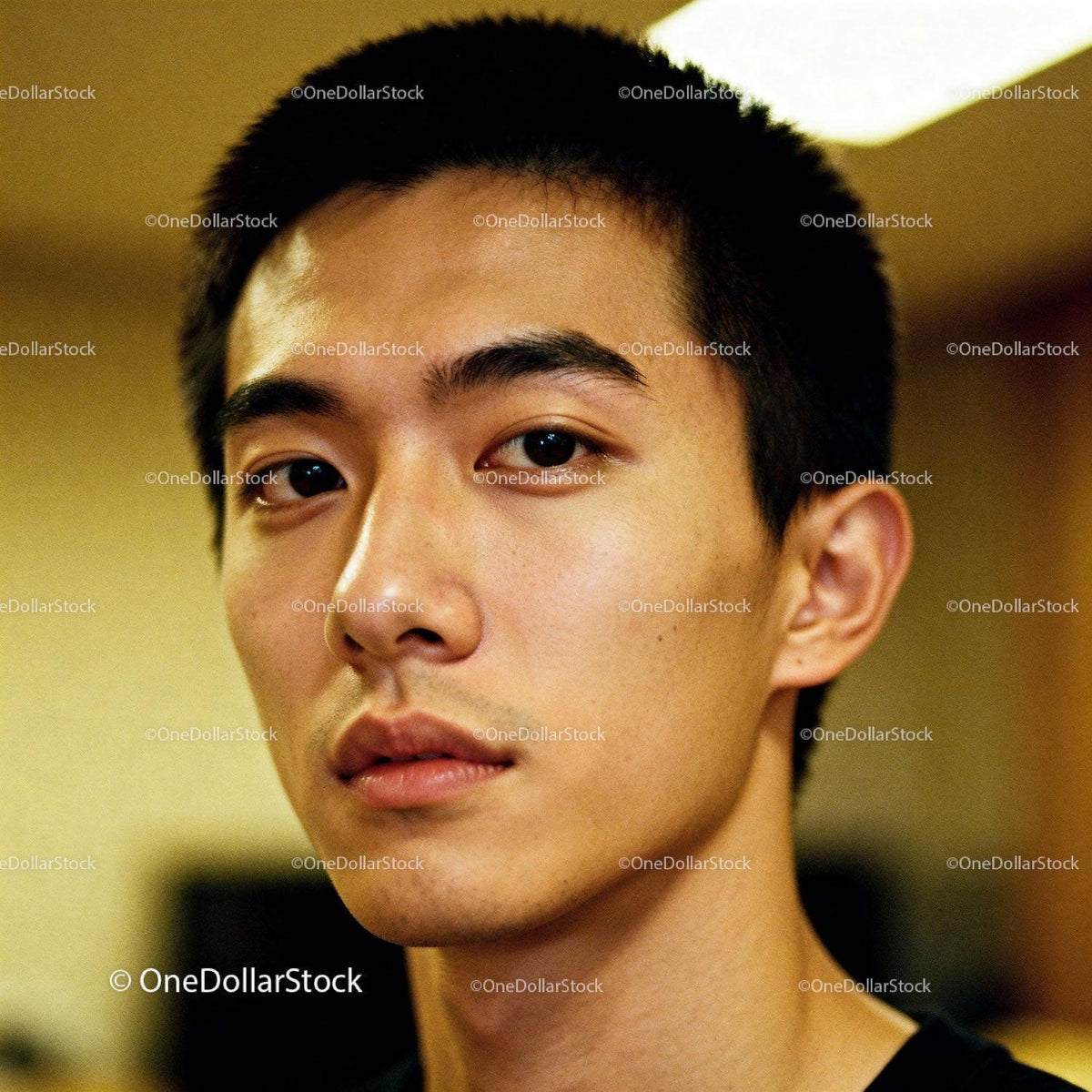 Thoughtful young man with focused expression indoors