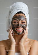 Woman with Black Facial Mask Enjoying Skincare Routine in Spa Setting