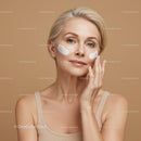 Elegant Mature Woman Applying Skin Care Cream for Facial Treatment