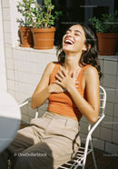 Young Woman Laughing Relaxed Outdoors in Bright Sunlight