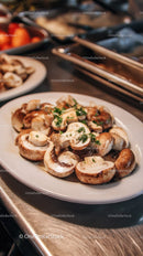 Fresh Sliced Mushrooms Garnished with Parsley on White Plate