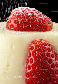 Fresh strawberries with powdered sugar on creamy cake