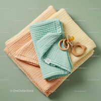 Soft pastel baby blankets with wooden pacifier and toy