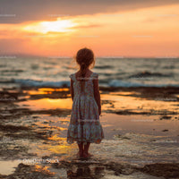 Silhouette of a Child at Sunset by the Ocean Shore