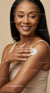 Elegant Mature Woman Applying Skincare Lotion for Healthy Glowing Skin