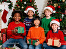 Happy children celebrating Christmas with gifts and decorations