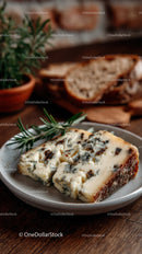 Blue Cheese on a White Plate with Fresh Herbs and Rustic Background