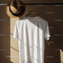 White T-shirt on Hanger with Straw Hat and Sunlight