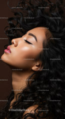 Close up of serene woman with flowing curly hair