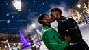 Couple sharing a tender kiss in snowy holiday lights