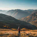 Scenic Mountain Landscape with Hiker Walking Through Autumn Foliage