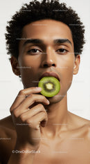 Young Man Biting Into Fresh Ripe Kiwi for Healthy Lifestyle