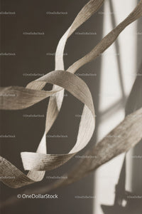 Close-up of White Plastic Ribbon Waste on Sandy Beach