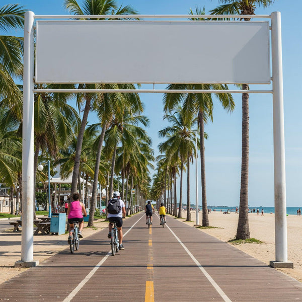 Cyclists riding along palm tree lined beach boardwalk JPG Mockup Image