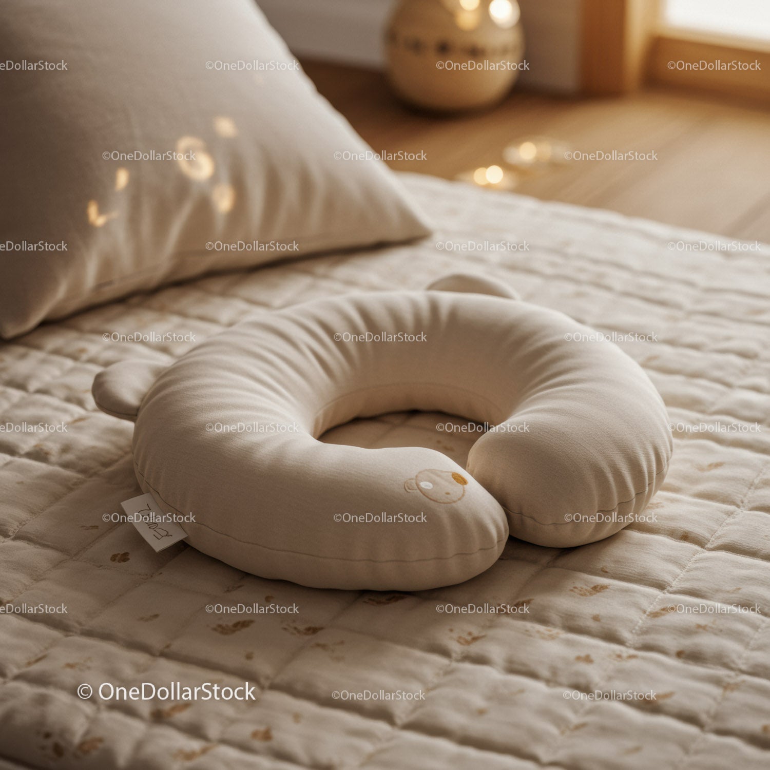 Cozy baby nursing pillow on soft quilted blanket