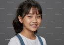 Smiling Young Girl with Braces Wearing Denim Overalls and White T-Shirt