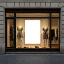 Fashionable summer dresses displayed in boutique window
