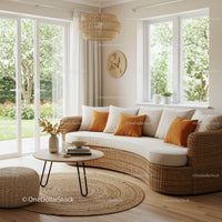 Cozy wicker sofa with orange pillows in bright living room