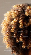 Close-up of natural curly hair with warm highlights