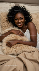 Smiling woman relaxing with cozy soft pillow in bed