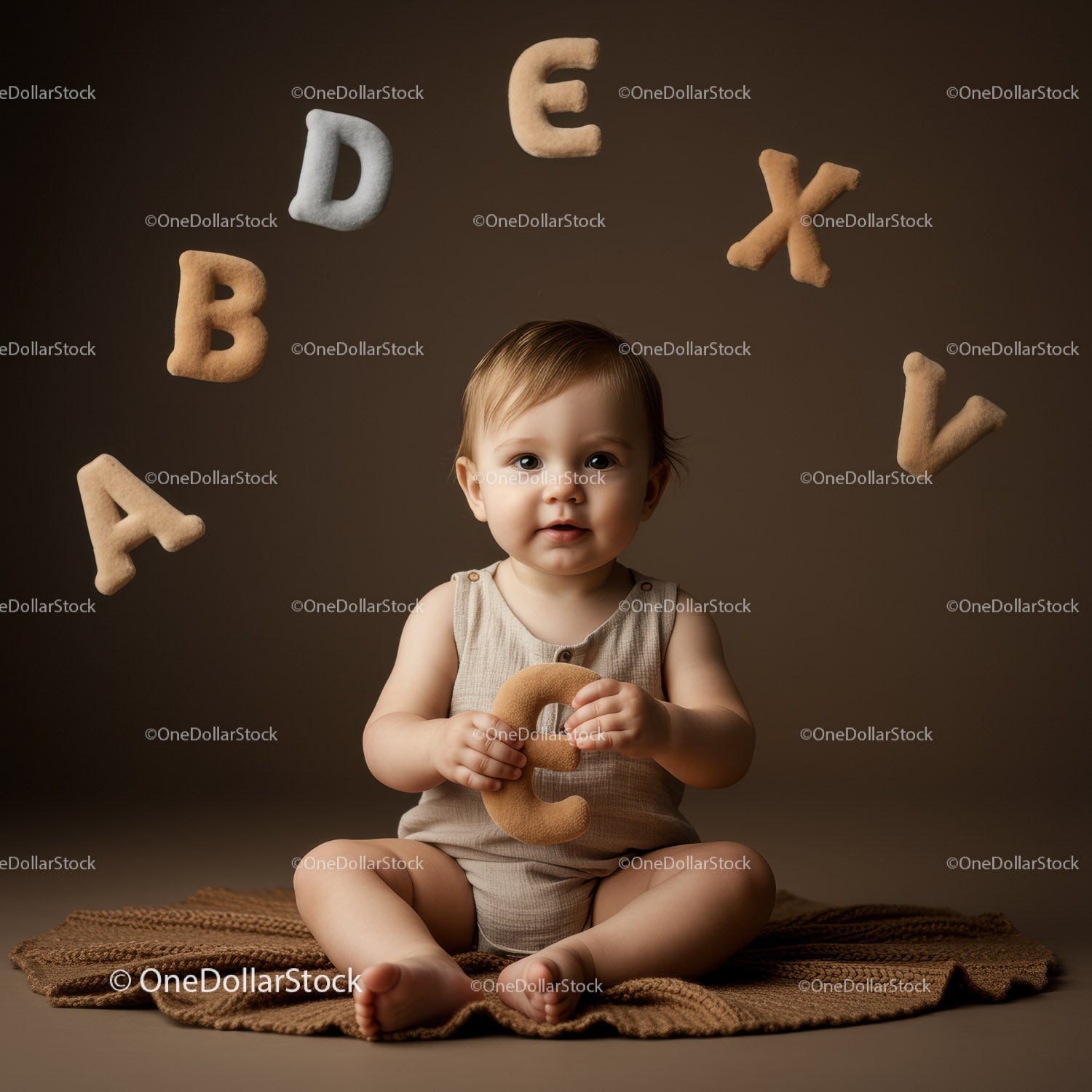 Cute Baby Sitting with Soft Alphabet Letters
