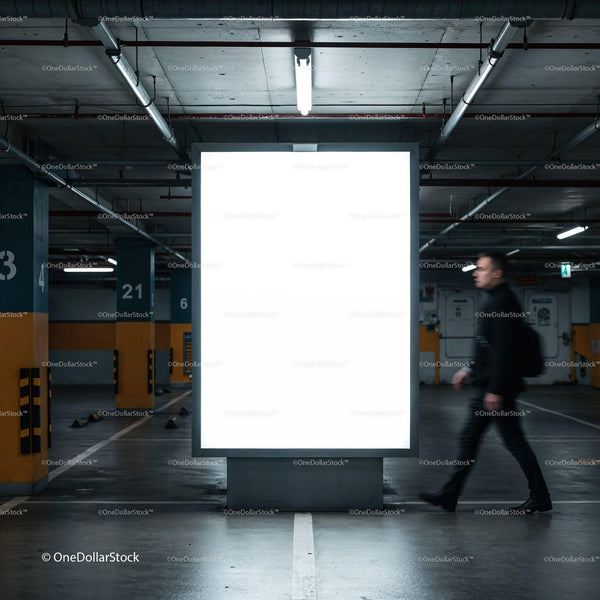 Empty illuminated billboard in underground parking garage JPG Mockup Image