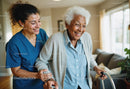Elderly Woman Assisted by Caregiver in Retirement Home