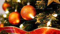 Sparkling Orange Ornaments Hanging on Christmas Tree