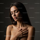 Serene woman with closed eyes and hand on chest